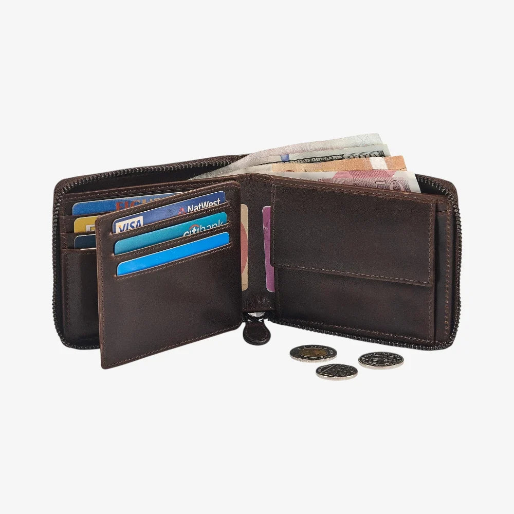 Open brown leather wallet with cards and coins on a white background
