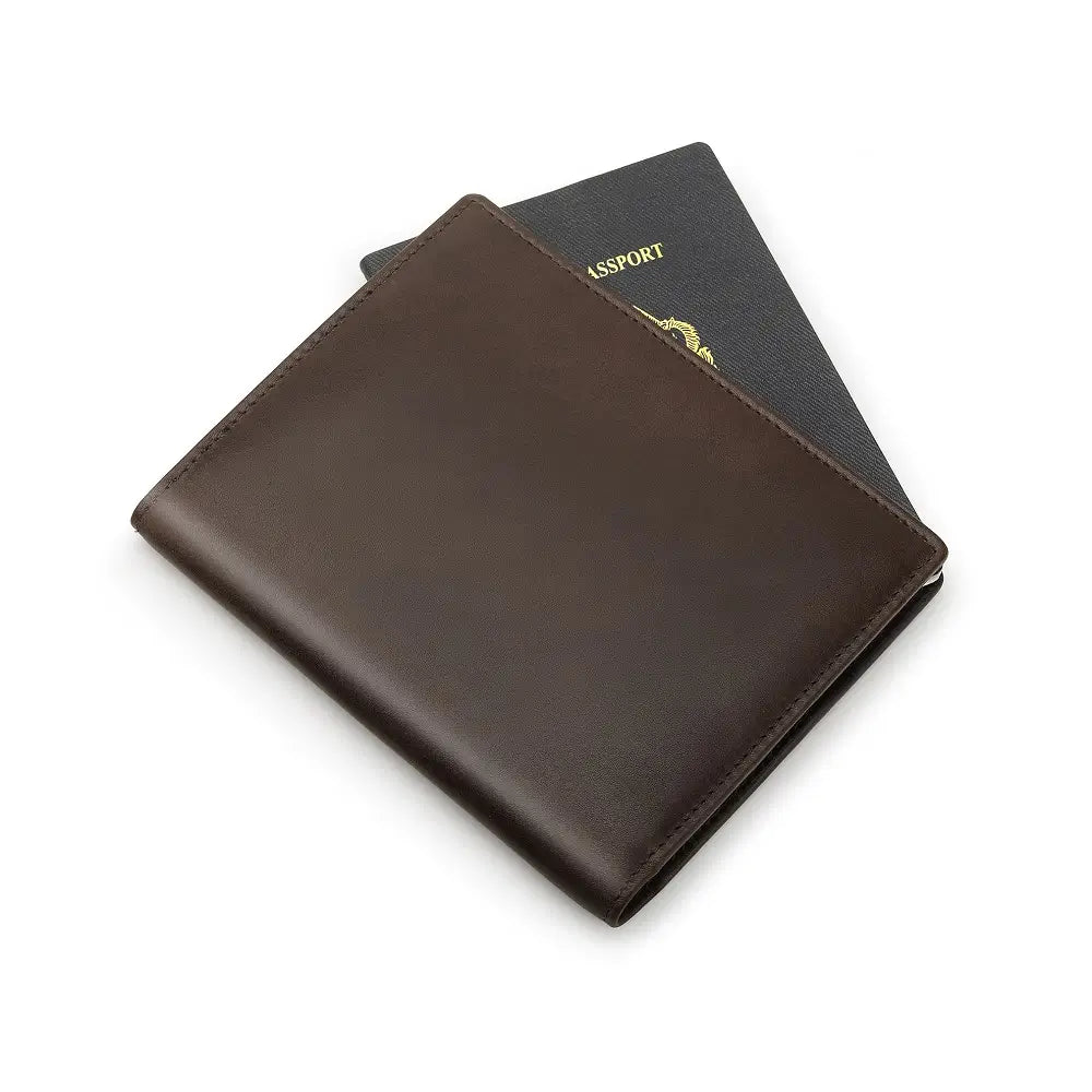 Brown leather passport holder with a passport on a white background