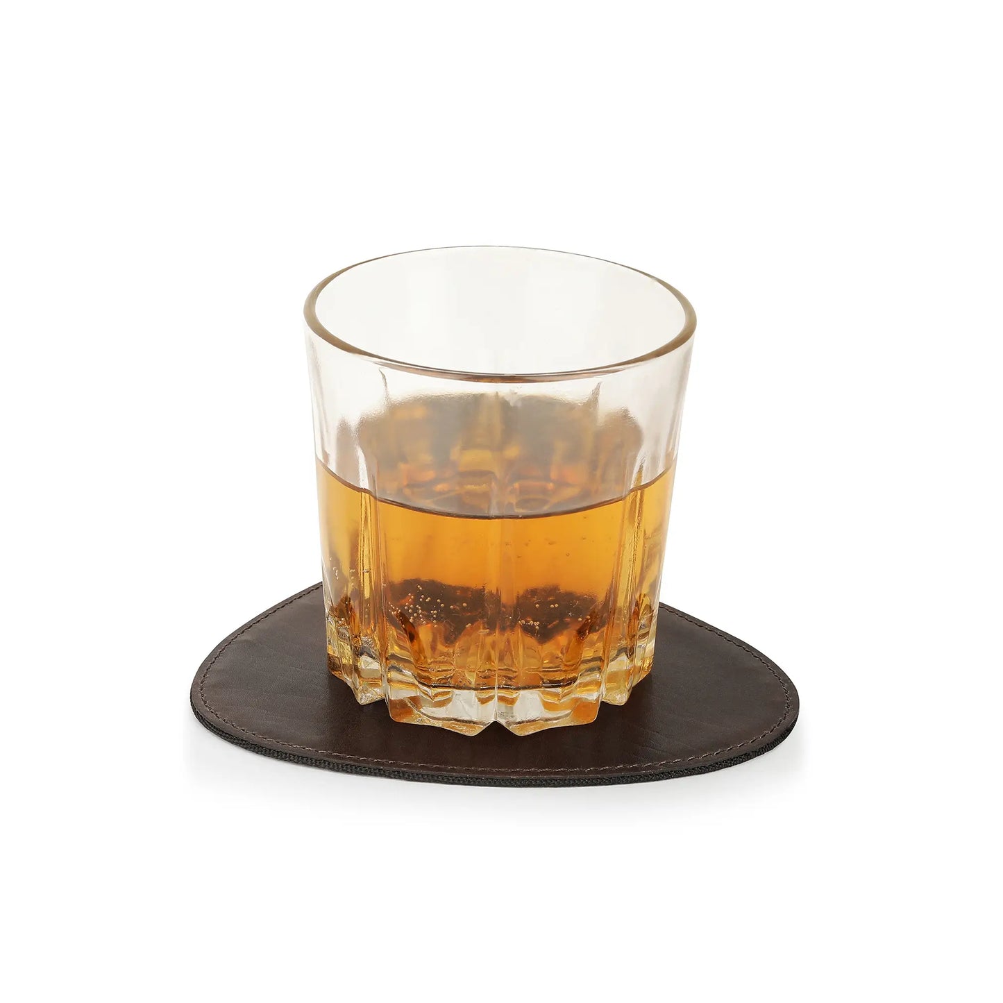 Glass of amber liquid on a brown leather  coaster with a white background