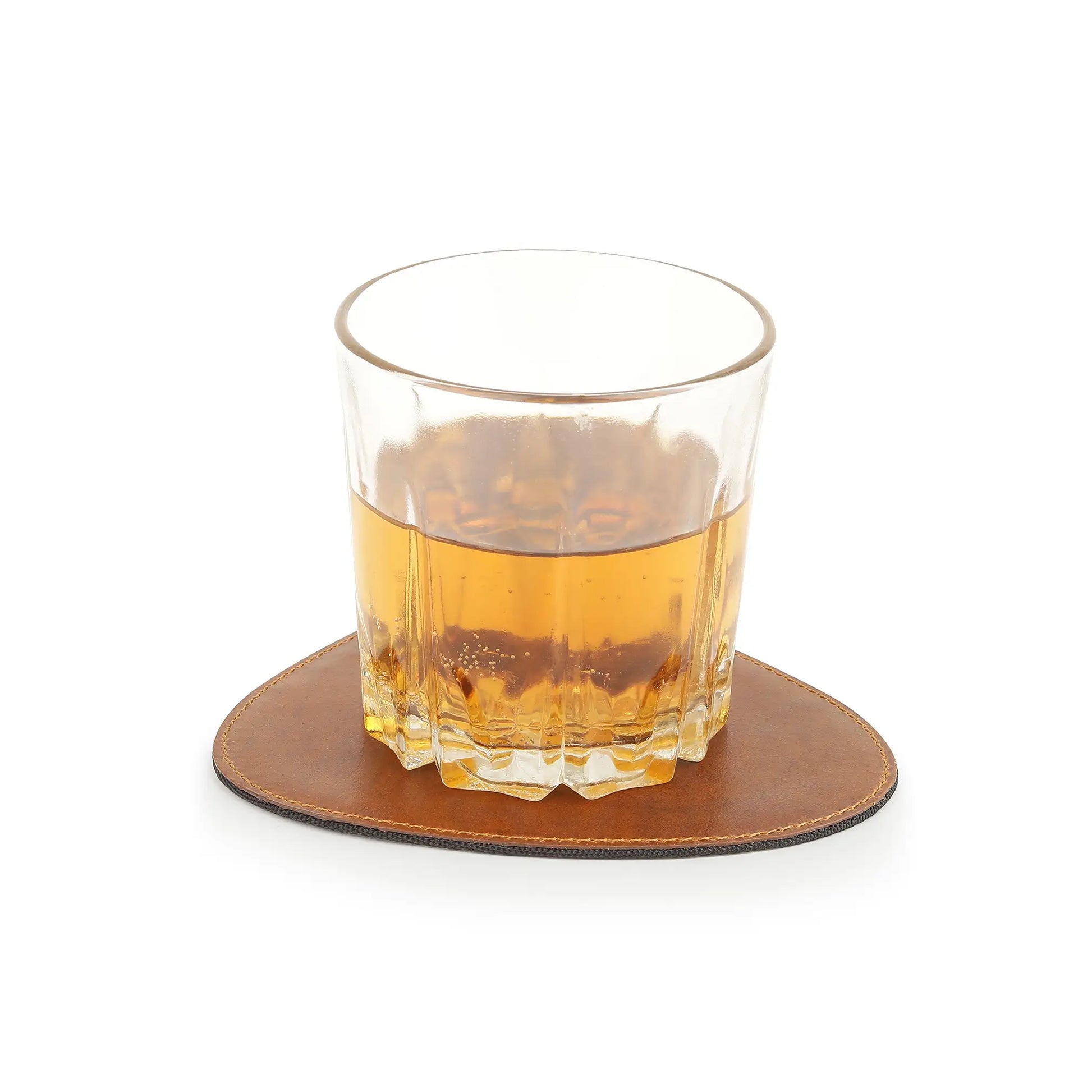 Glass of whiskey on a tan leather coaster with a white background
