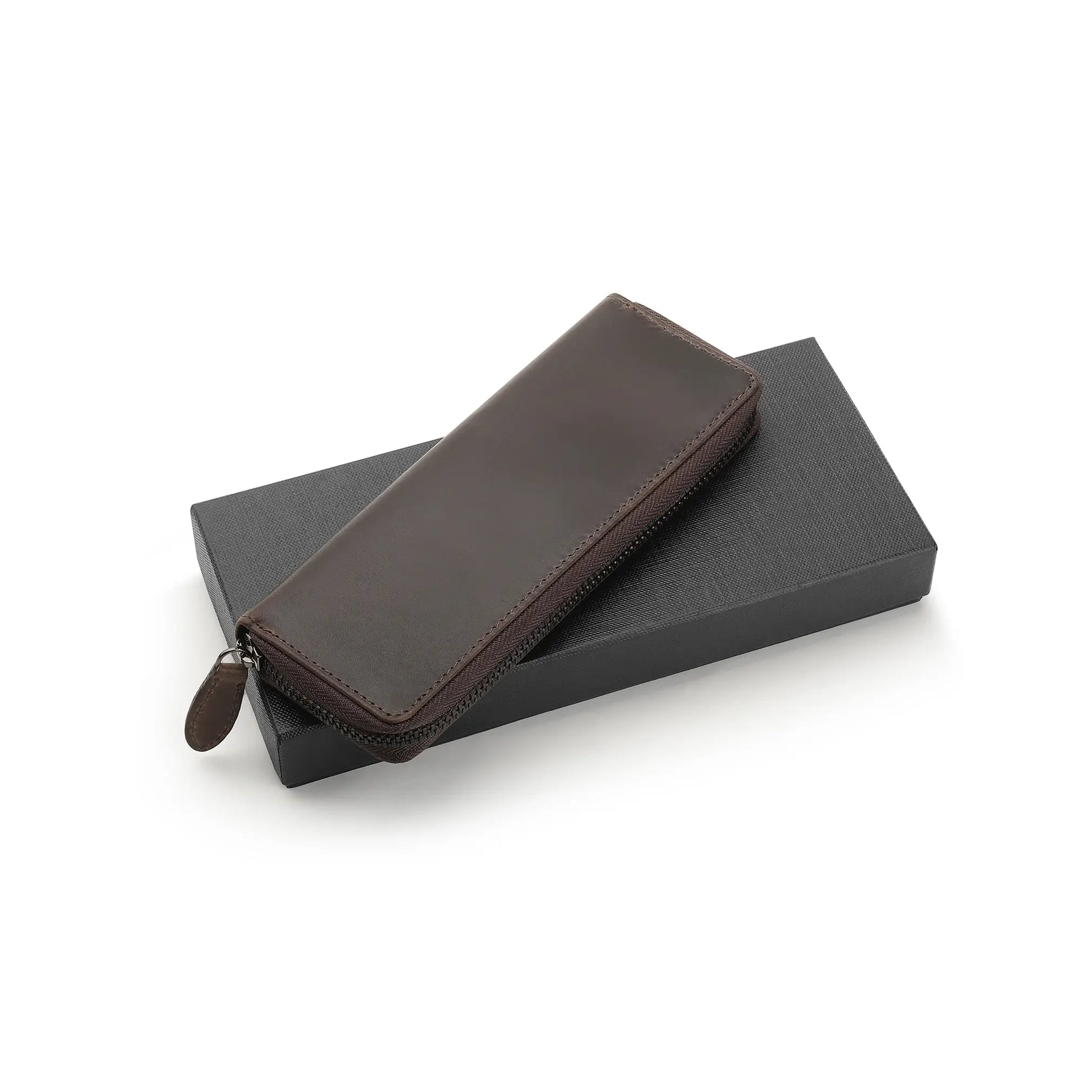 Brown leather pen case on a black box with a white background