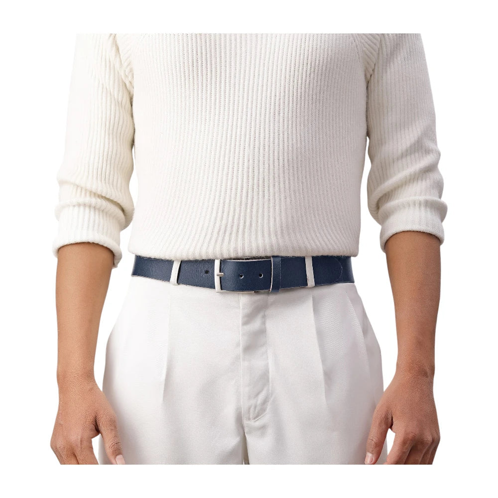 Person wearing a white sweater, white pants, and a blue belt on a white background